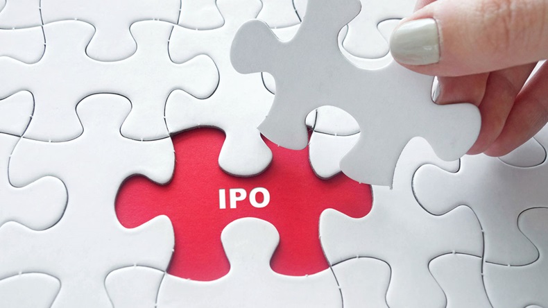 IPO letter revealed as puzzle piece is removed by a hand