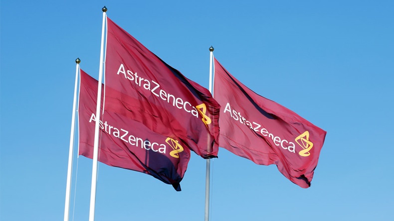 Sodertalje, Sweden - April 27, 2014: Three purple flags with the logo for Atrazeneca flying in the wind on top of the flagpoles against the blue sky.