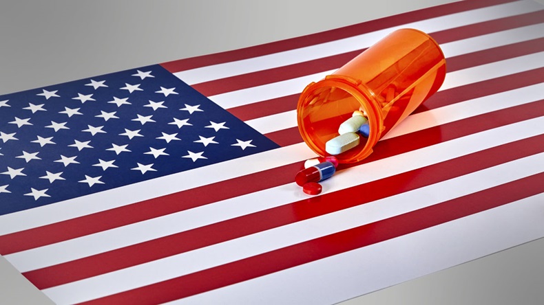 Prescription medications laying on top of an American Flag isolated on white 
