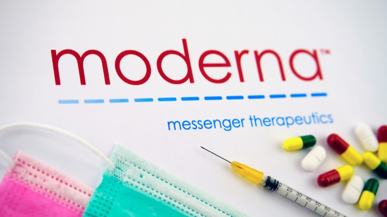 Stone / United Kingdom - February 11 2020: Moderna medical compamy logo seen on the brochure with the viral masks, syringe and pills. Photo concept. Selective focus.
