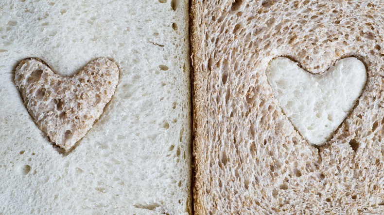 white bread slice with a brown wholemeal heart, and a wholemeal bread slice with a white heart