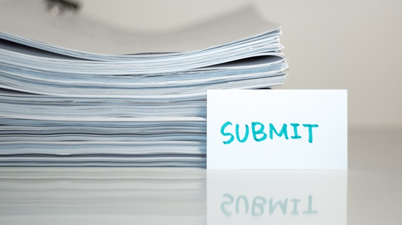 Submit; Stack of Documents on white desk and Background. - Image