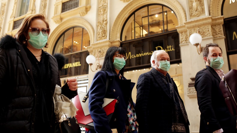 MILANO,ITALY- FEBRUARY 22, 2020: Coronavirus in Italy.Protective mask.Tourists in face masks at the Wiktor Emanuel II Gallery