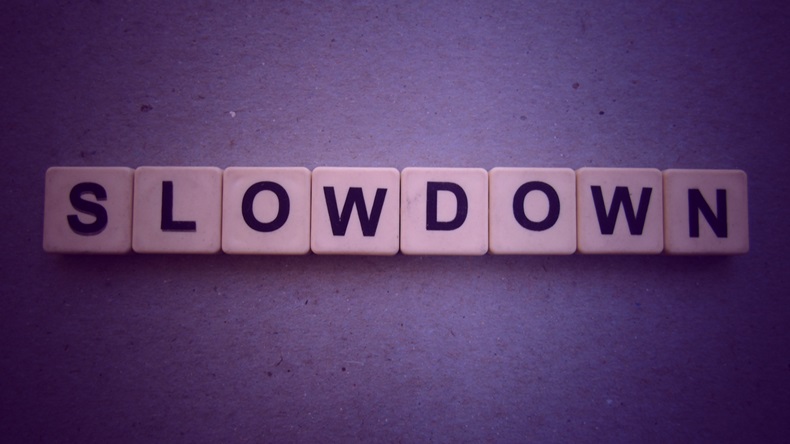 Slowdown, word cube with background.