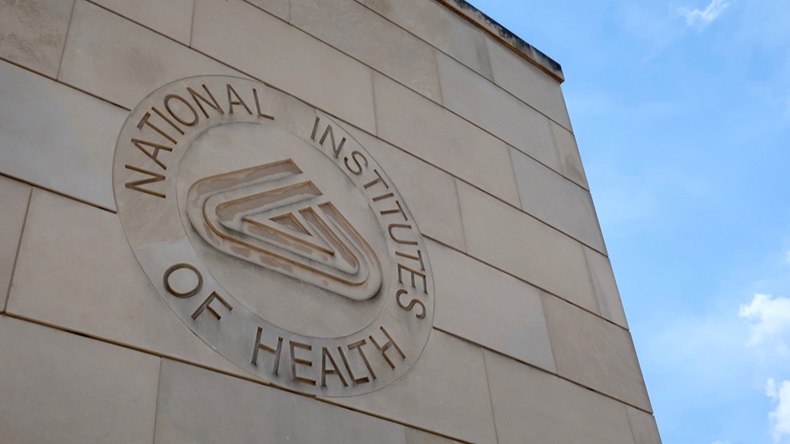 BETHESDA, MD - JUNE 29, 2019: NIH NATIONAL INSTITUTES OF HEALTH sign emblem seal on gateway center entrance building at NIH campus