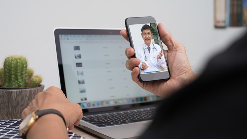 Patient listening to friendly doctor via mobile smartphone at home or office, telemedicine, e health. People watching friendly doctor on health channel internet live broadcast, medical online concept