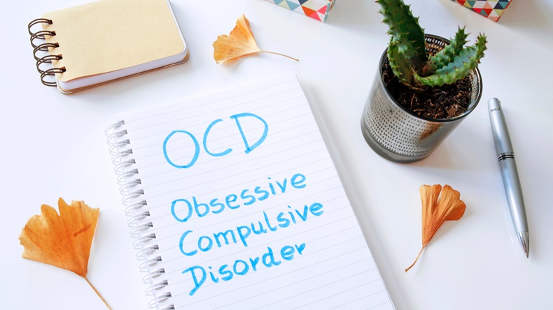 OCD Obsessive Compulsive Disorder written in notebook on white table