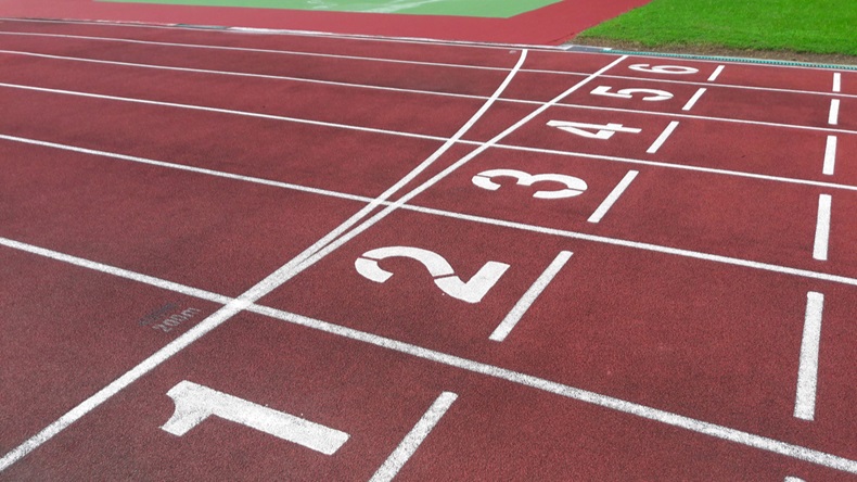 Numbers on red running track. Start and Finish point of a race track in a stadium
