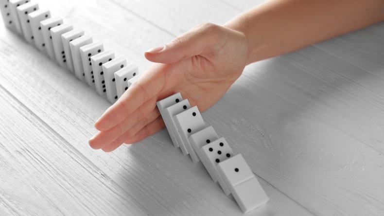 Hand stopping dominos