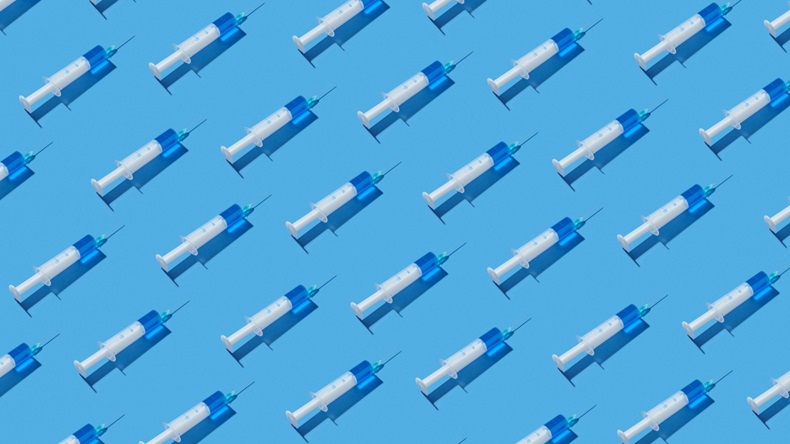 Medical diagonal pattern from disposable plastic syringes of blue serum or vaccine