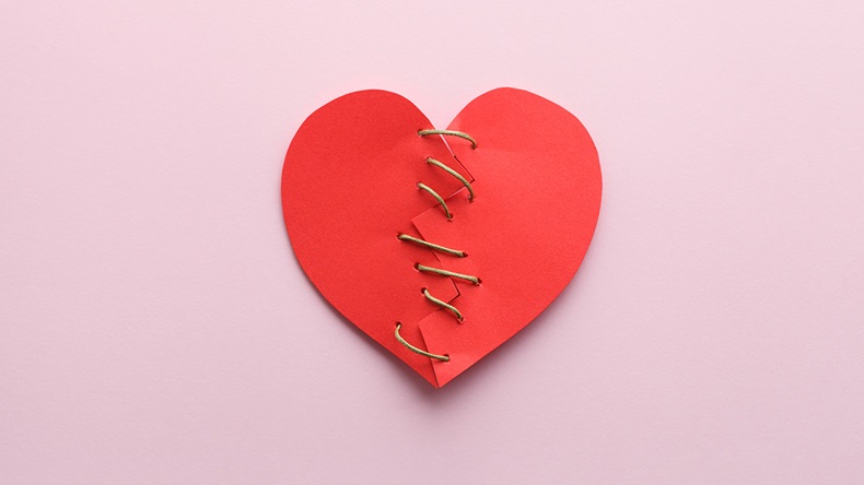 broken paper red heart isolated on pink background, top view, flat lay