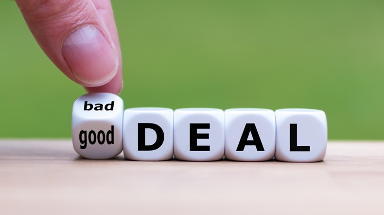 Hand turns a dice and changes the expression "bad deal" to "good deal"