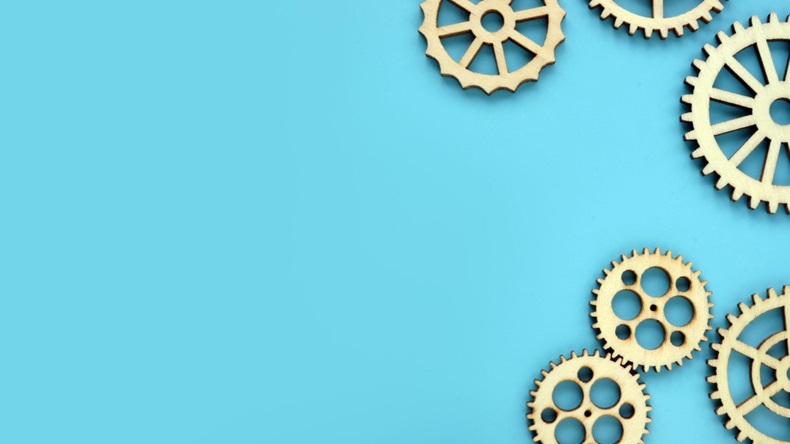 Blue background with wooden gears. Mind works and new ideas concept.