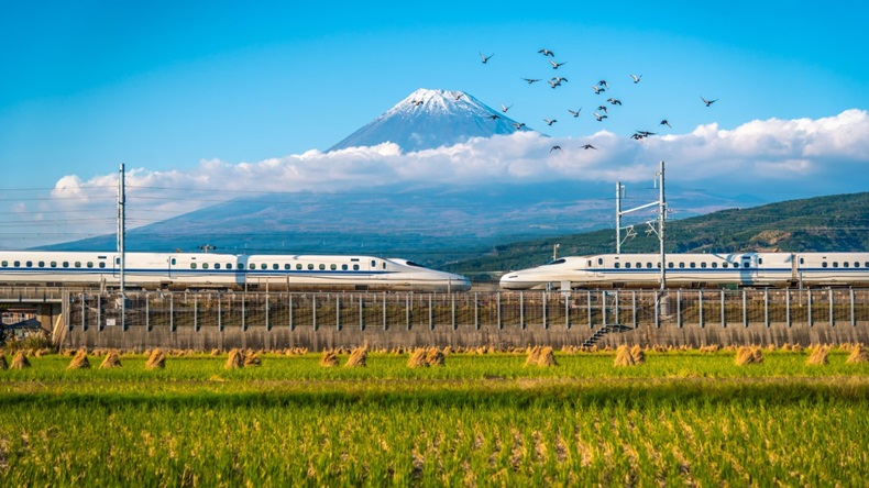 Mt. Fuji with Shinkansen train and rice field at Shizuoka, Japan.