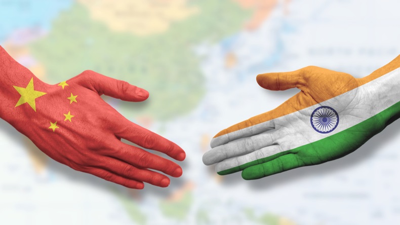 Hands painted with India and China flags going for a handshake