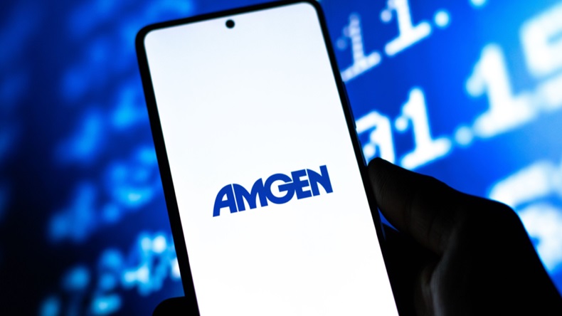  Amgen logo on phone screen in front of stock prices