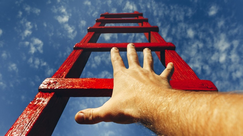 hand reaching out to climb ladder