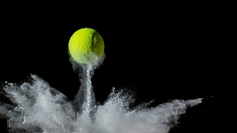 Yellow ball on white background, bounce motion with white powder