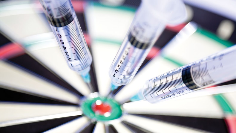 Syringes stuck in a dartboard